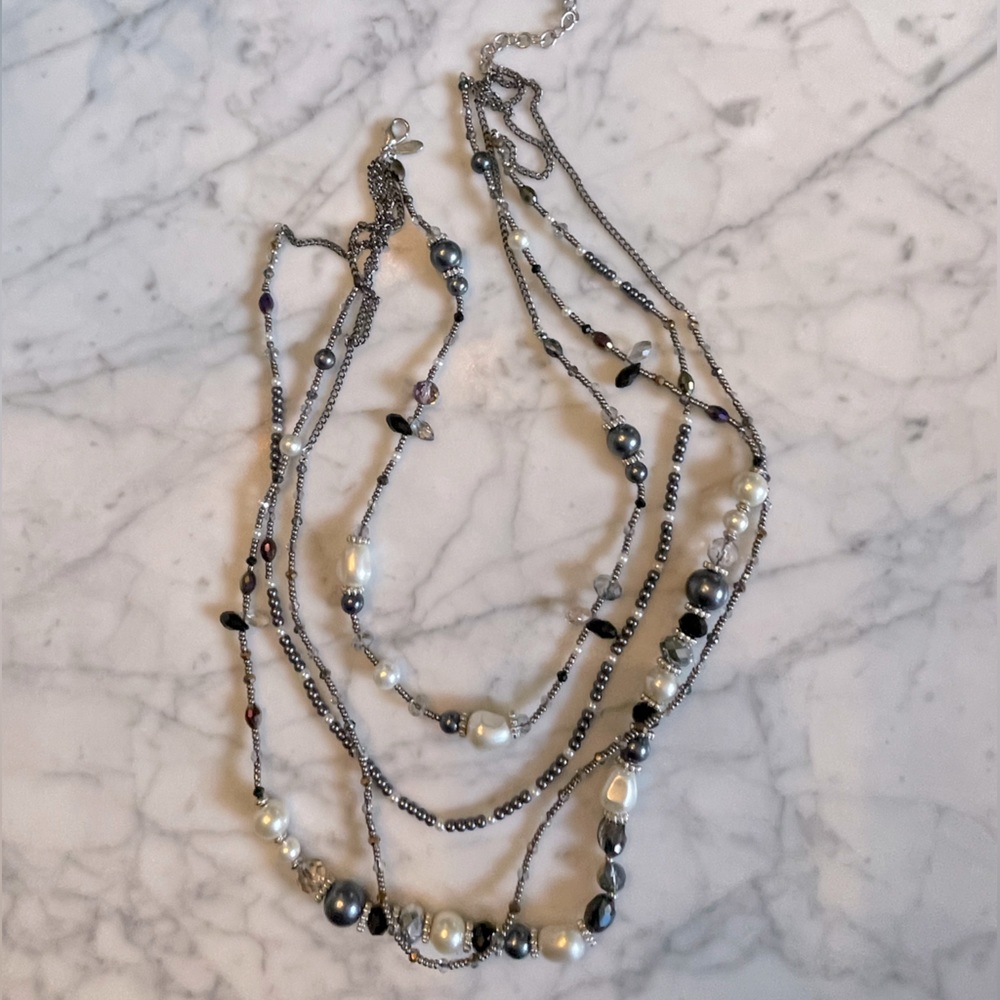 Costume jewelry necklace.  Faux pearl, black and crystal on black chain.
